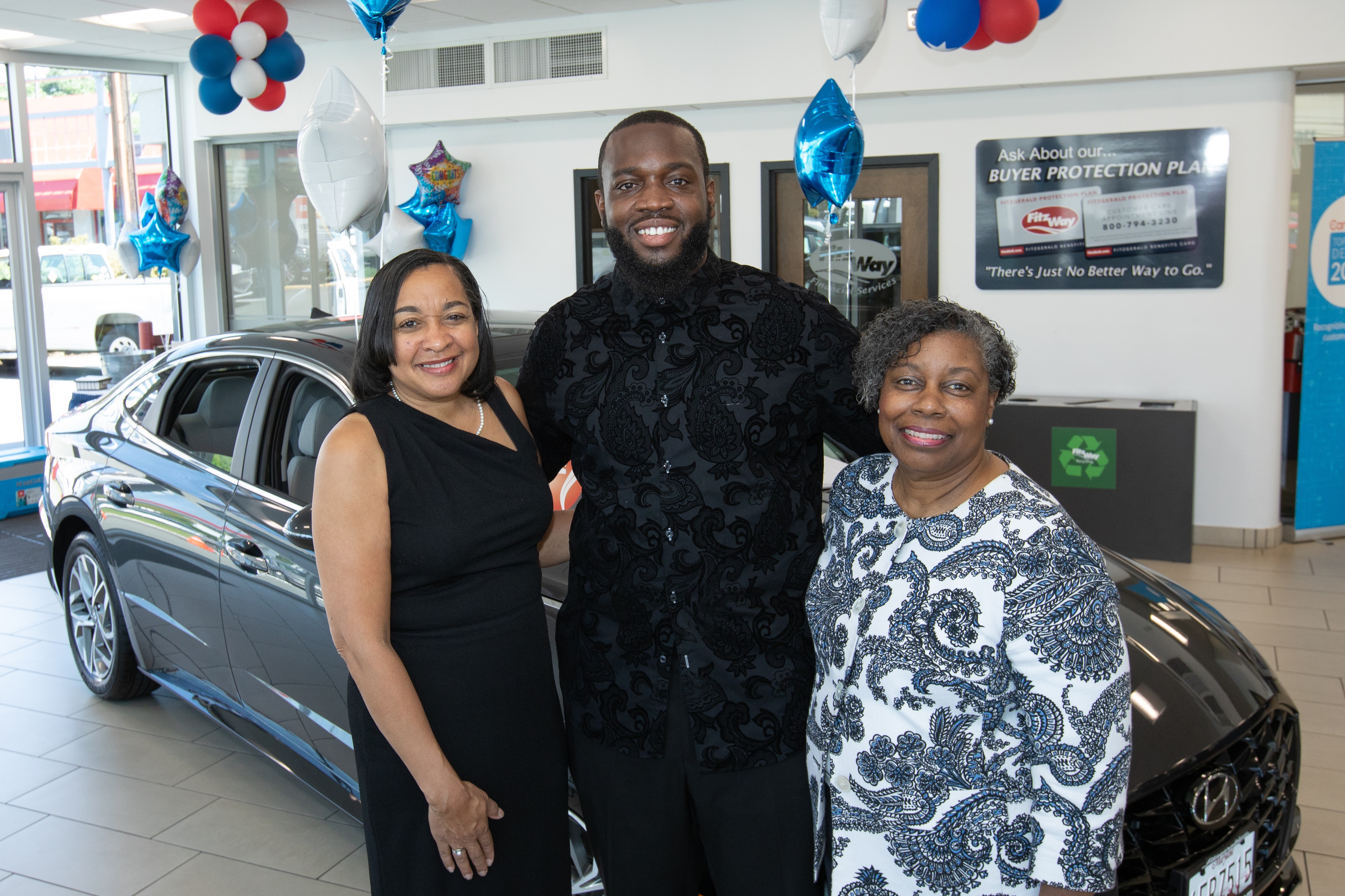2021 Teacher of the Year Joseph Bostic Jr. with Foundation Executive Director Yolanda Johnson Pruitt (right) and his wife (left)